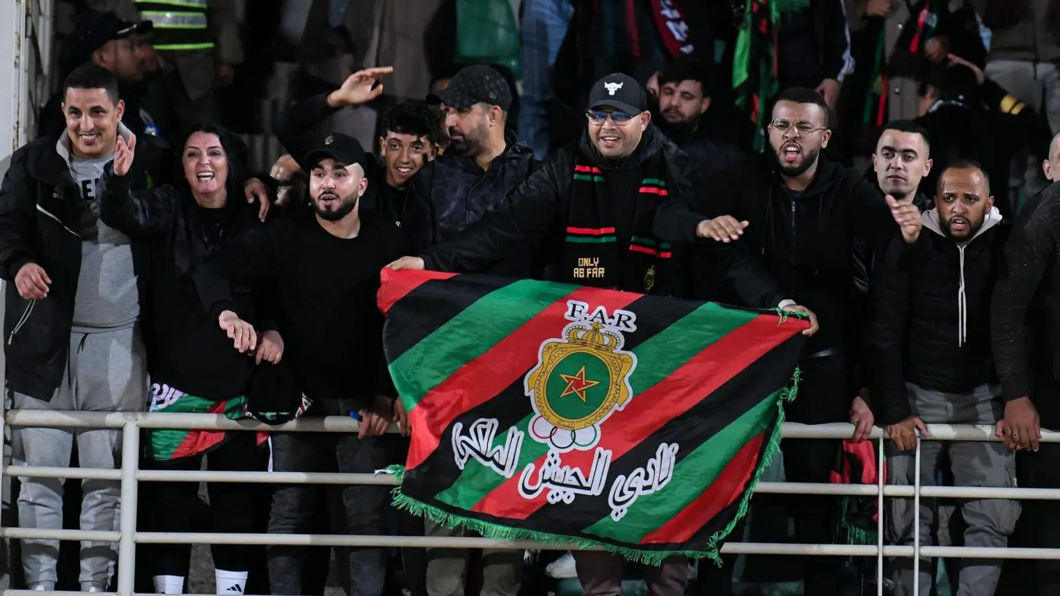 FAR fans in a stadium holding the club's flag